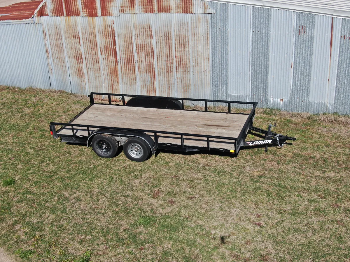 16-foot utility trailer for rent in Aubrey TX - Versatile trailer with wood deck and side rails for hauling equipment